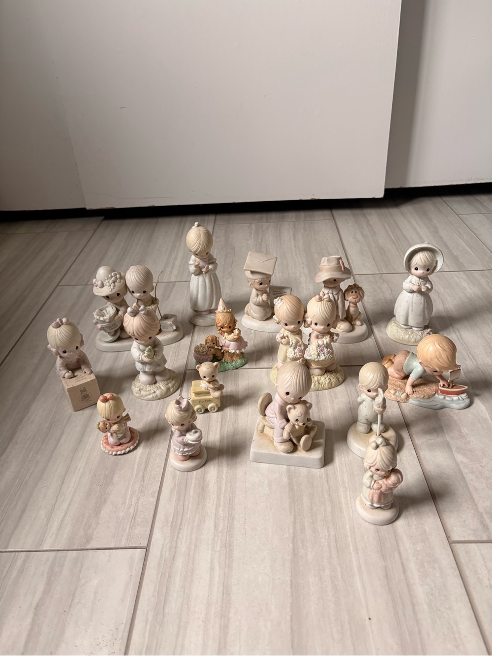 Lot of 16 Precious Moments Porcelain Figurines Various Sizes and Styles.